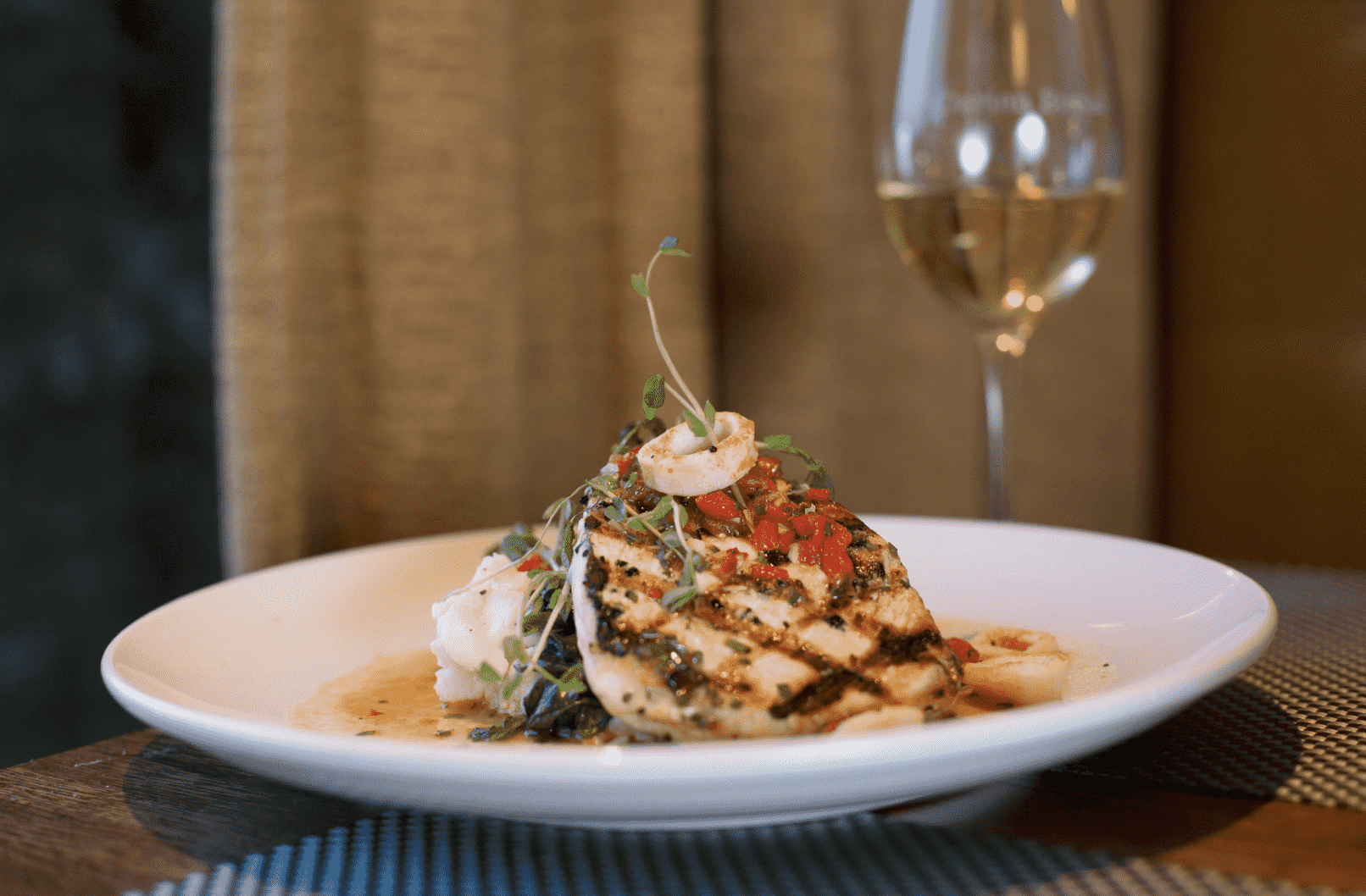 Grilled Swordfish with Sautéed Spinach, Grilled Calamari, Romesco, and Creamy Mashed Potatoes